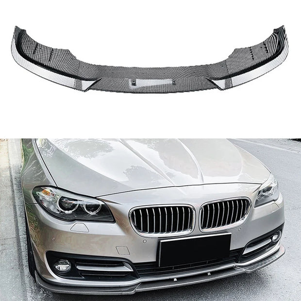 Carbon fiber car bumper lip on a white background with a car below.