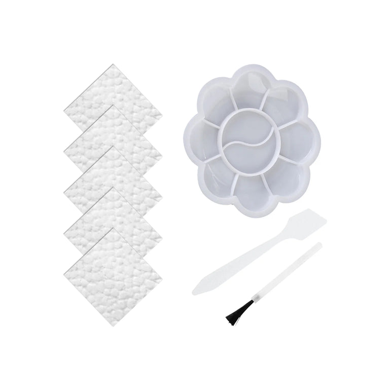 Set of white foam pads, a flower-shaped paint palette, and a brush on a white background